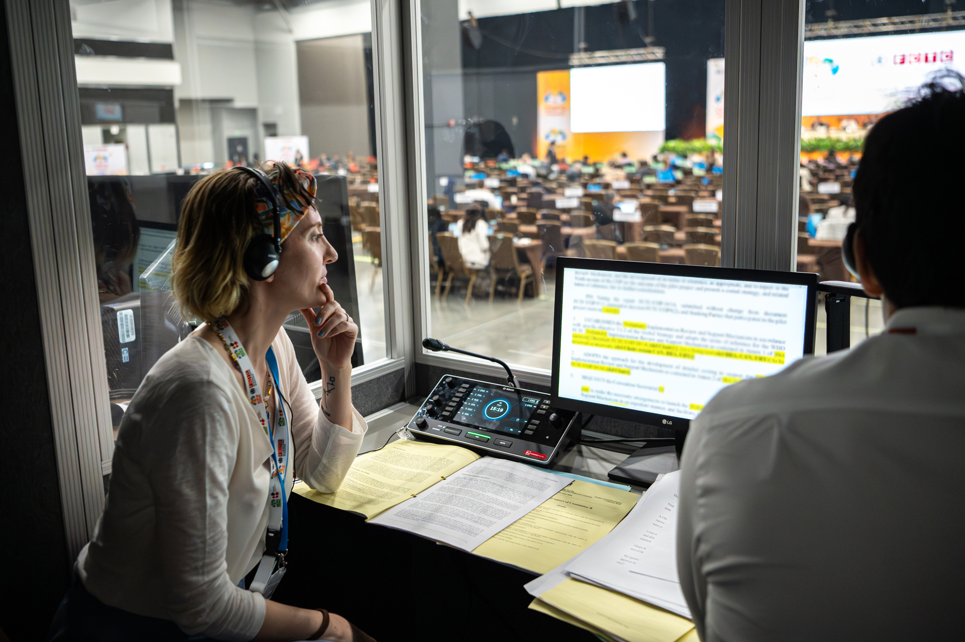 Susan Isko interpreting from the booth at an international conference in Panama.